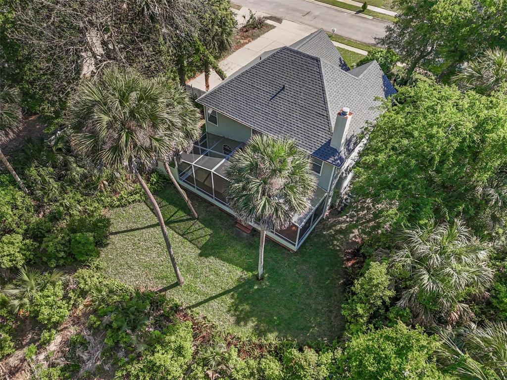 An aerial view shows a two-story house with a screened-in porch and palm trees — 9 WHITEHALL COURT, FLAGLER BEACH, FL