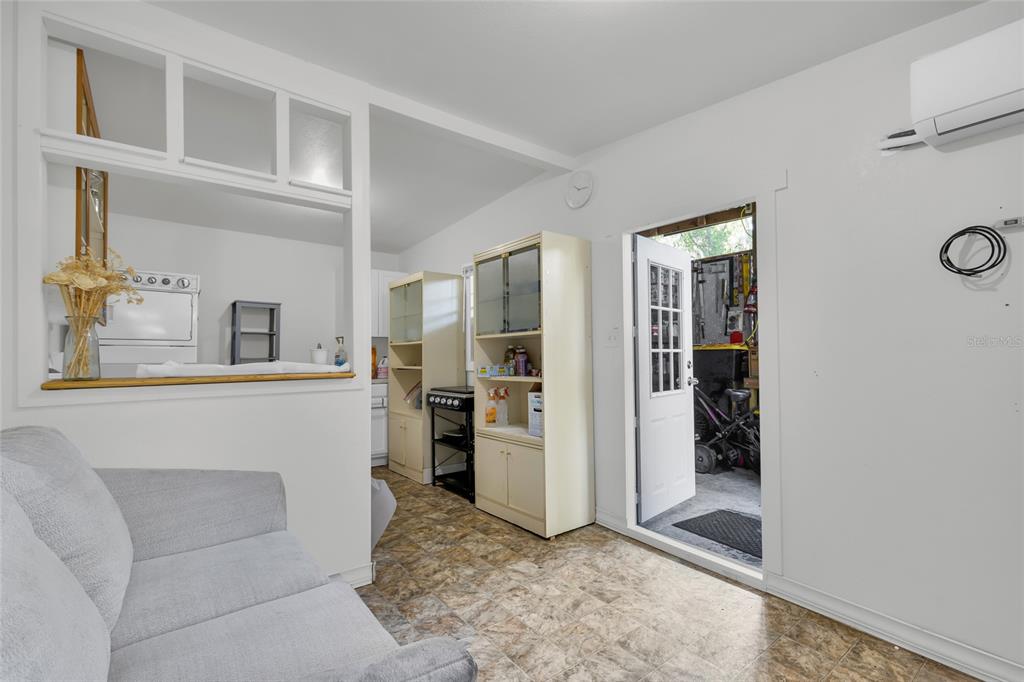 A living area with a pass-through window to the kitchen and an open doorway — 2015 NE 12TH AVENUE, OCALA, FL