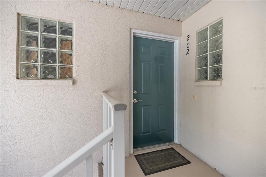 An aerial view of a multi-story residential building overlooking a golf course — 801 MONTROSE DRIVE UNIT 202, VENICE, FL