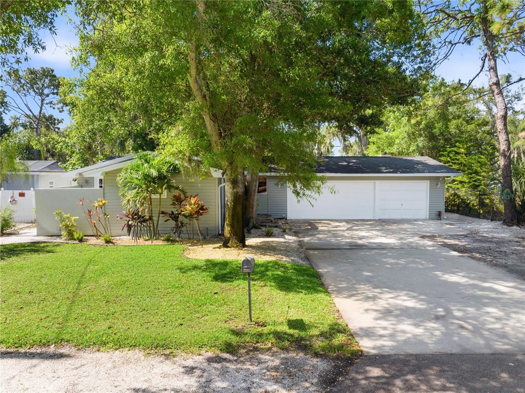 A single-story house with a two-car garage, a concrete driveway, and a front lawn — 13012 96TH AVENUE, SEMINOLE, FL