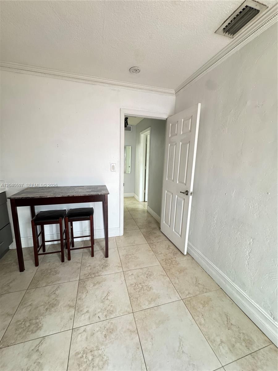 A small dining area with a table and two stools leads into a hallway — 11340 SW 41st Ter, Miami FL 33165, MIAMI, FL