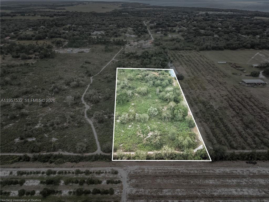 An aerial view shows a rectangular plot of undeveloped land surrounded by trees and fields — 701 Jolly Lane, Lorida FL 33857, LORIDA, FL
