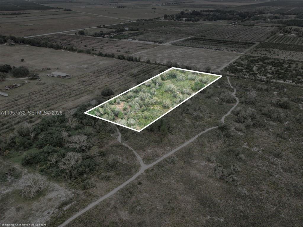 An aerial view shows a rectangular plot of land outlined in white amidst rural fields — 701 Jolly Lane, Lorida FL 33857, LORIDA, FL