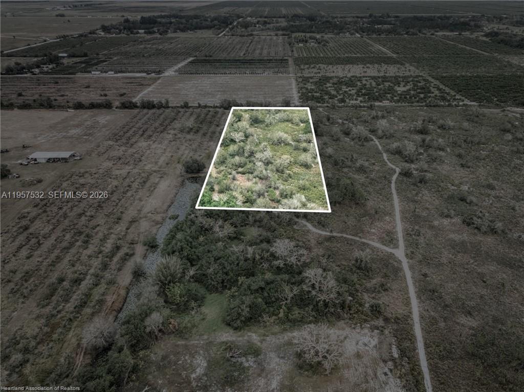 An aerial view shows a rectangular plot of land outlined in white amidst rural vegetation — 701 Jolly Lane, Lorida FL 33857, LORIDA, FL
