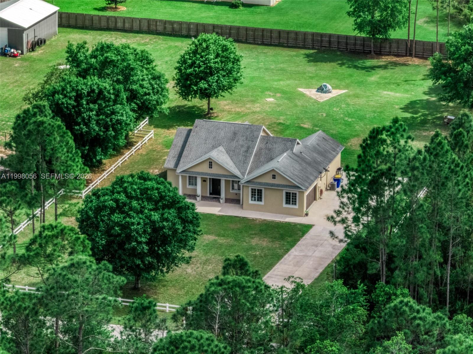 An aerial view shows a tan house with a gray roof on a large lot — 2009 Flower, Sebring FL 33875, SEBRING, FL