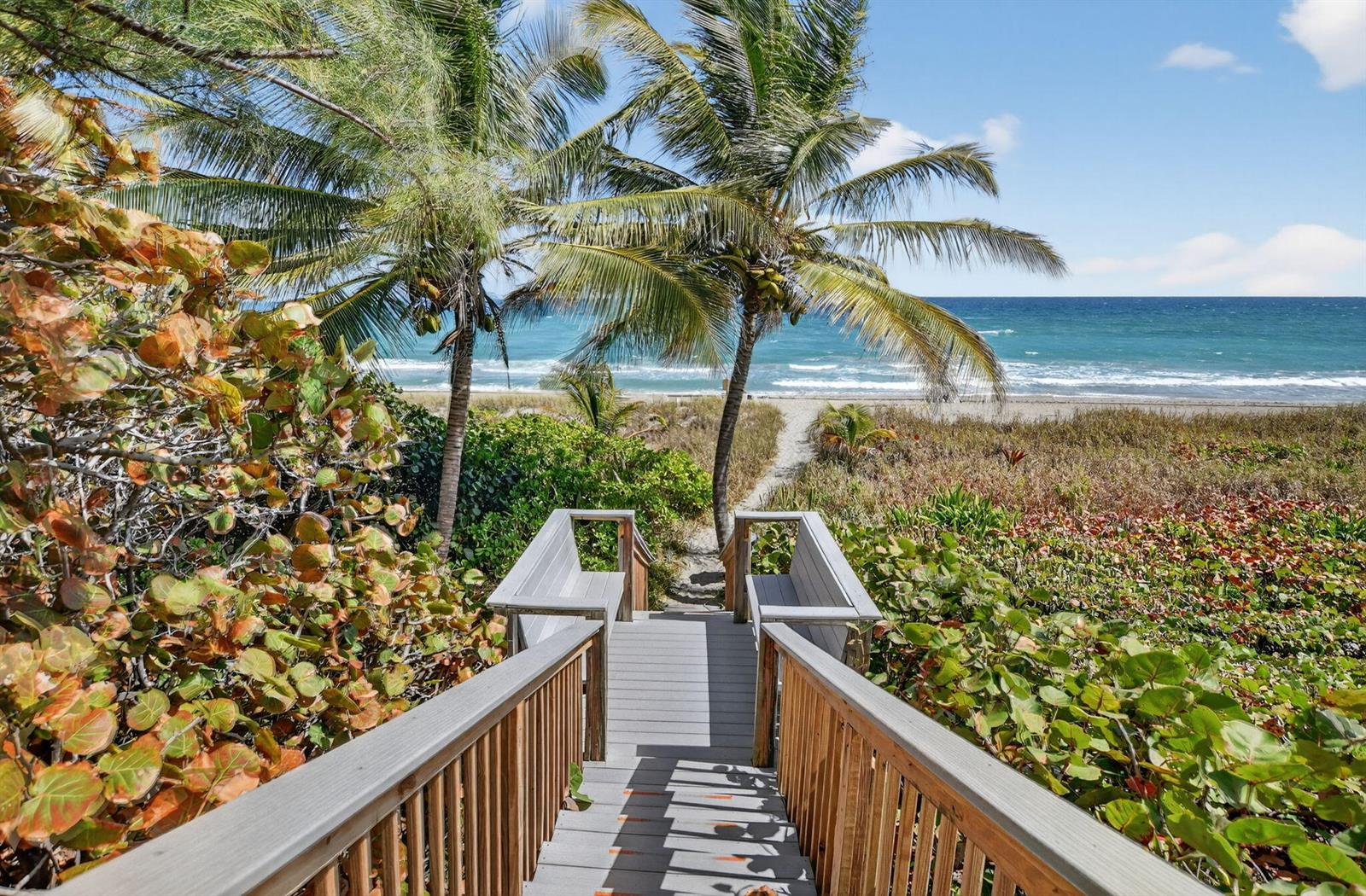 A wooden staircase leads down through tropical vegetation toward a sandy beach and the ocean — 2121 N Ocean Boulevard # 705e, Boca Raton FL 33431, BOCA RATON, FL