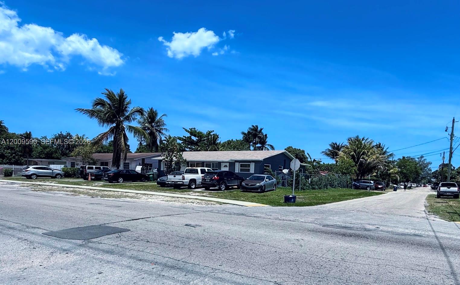 A single-story gray house with a driveway full of cars sits on a corner lot — 14615 NE 14th Ave, Miami FL 33161, MIAMI, FL