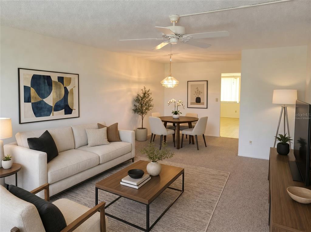 A living and dining room area features neutral furniture, a ceiling fan, and carpeted floors — 4890 BAY STREET NE UNIT 336, ST PETERSBURG, FL