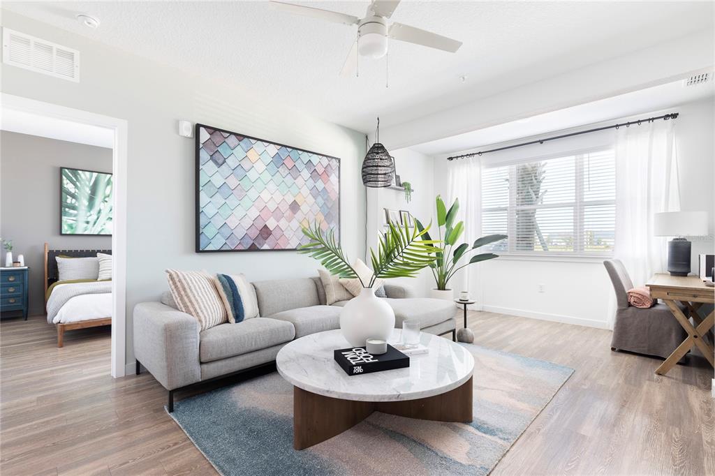 A living room features a grey sectional sofa, marble coffee table, and a large wall print — 10105 SELTEN WAY, ORLANDO, FL