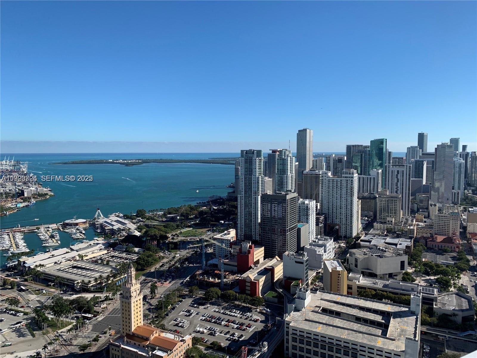 An aerial view of the Miami skyline featuring high-rise buildings, a marina, and the bay — 851 NE 1st Ave # 4911, Miami FL 33132, MIAMI, FL