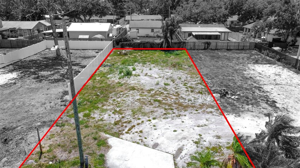 An aerial view shows a rectangular, vacant residential lot outlined in red — 1120 35TH STREET W, BRADENTON, FL