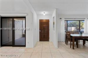 An interior view showing a tiled entryway, a wooden front door, and a dining area — 1145 N Shannon # 39, Indialantic FL 32903, INDIALANTIC, FL