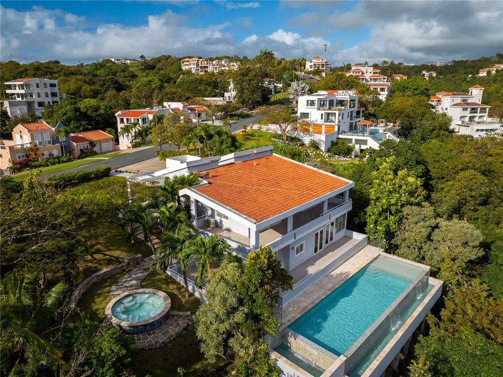 An aerial view of a multi-story house with a red tile roof, pool, and hot tub — 15 PORT ROAD, HUMACAO, PR