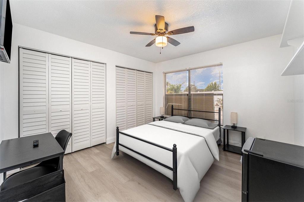A bedroom features a bed, a desk, two closets, and a ceiling fan — 334 DAGAMA COURT, KISSIMMEE, FL