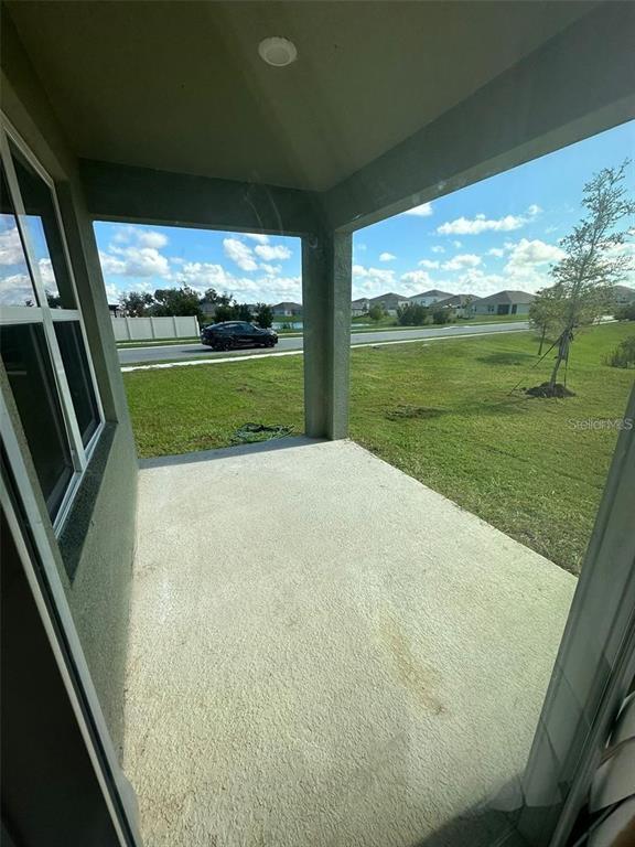 A kitchen island with granite countertops overlooks an open-concept living area with tile flooring — 1071 BROOKLET DRIVE, DAVENPORT, FL
