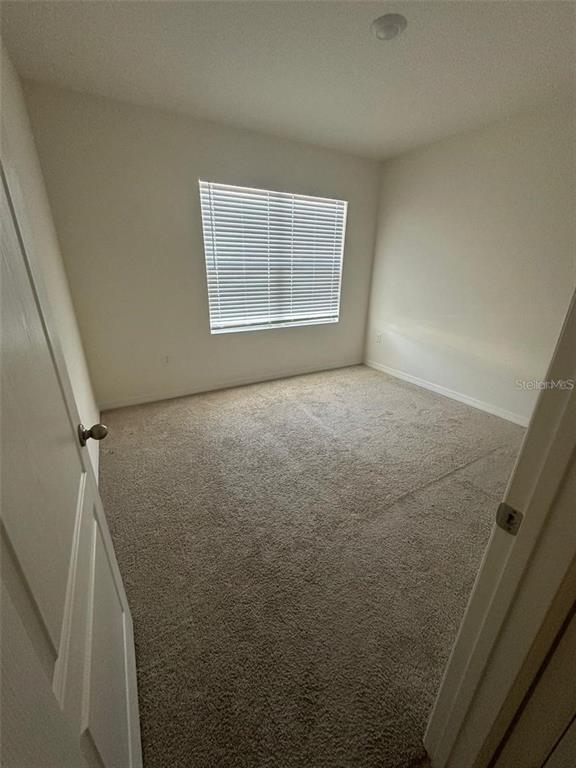 A bathroom features a white vanity, a toilet, and a shower-tub combination with tile flooring — 1071 BROOKLET DRIVE, DAVENPORT, FL