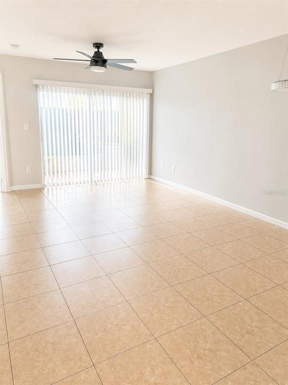 A parking lot with two numbered spaces in front of a tan building — 13226 GALICIA STREET UNIT 102, ORLANDO, FL