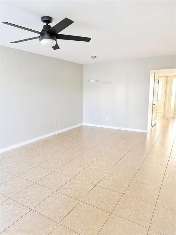 An aerial view of a two-story apartment building with a tiled roof and parking lot — 13226 GALICIA STREET UNIT 102, ORLANDO, FL