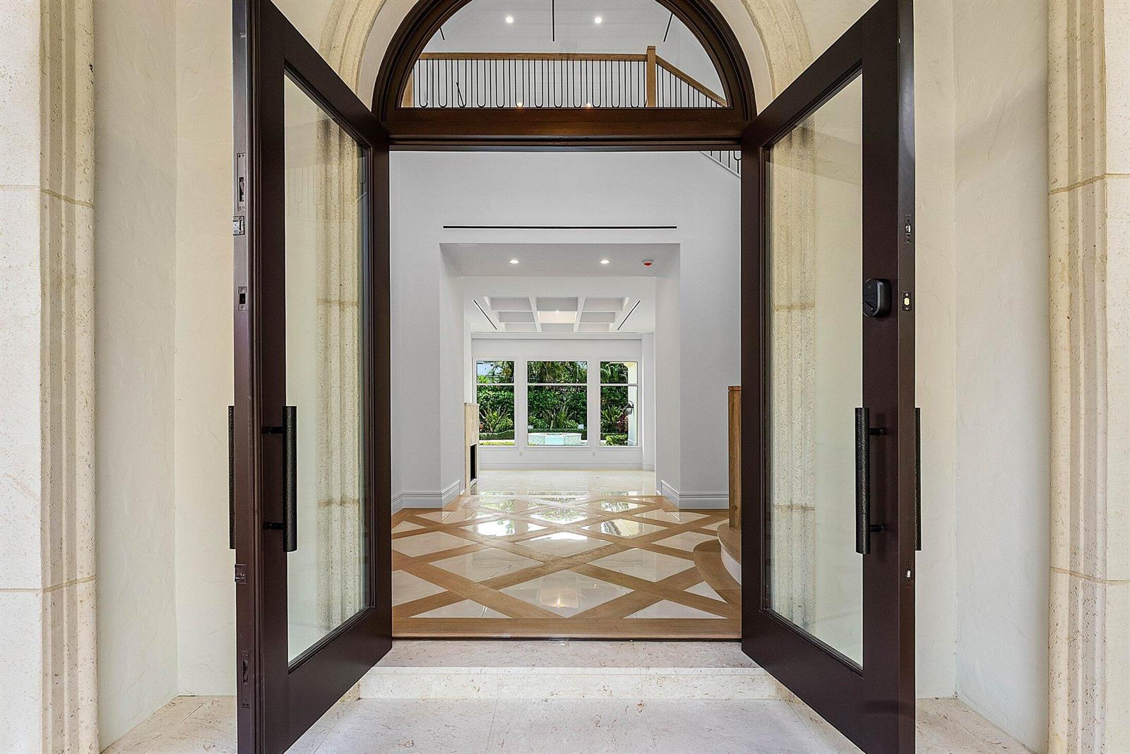 An open double door reveals a bright foyer with patterned flooring and a distant view — 2002 NW 4th Avenue, Delray Beach FL 33444, DELRAY BEACH, FL