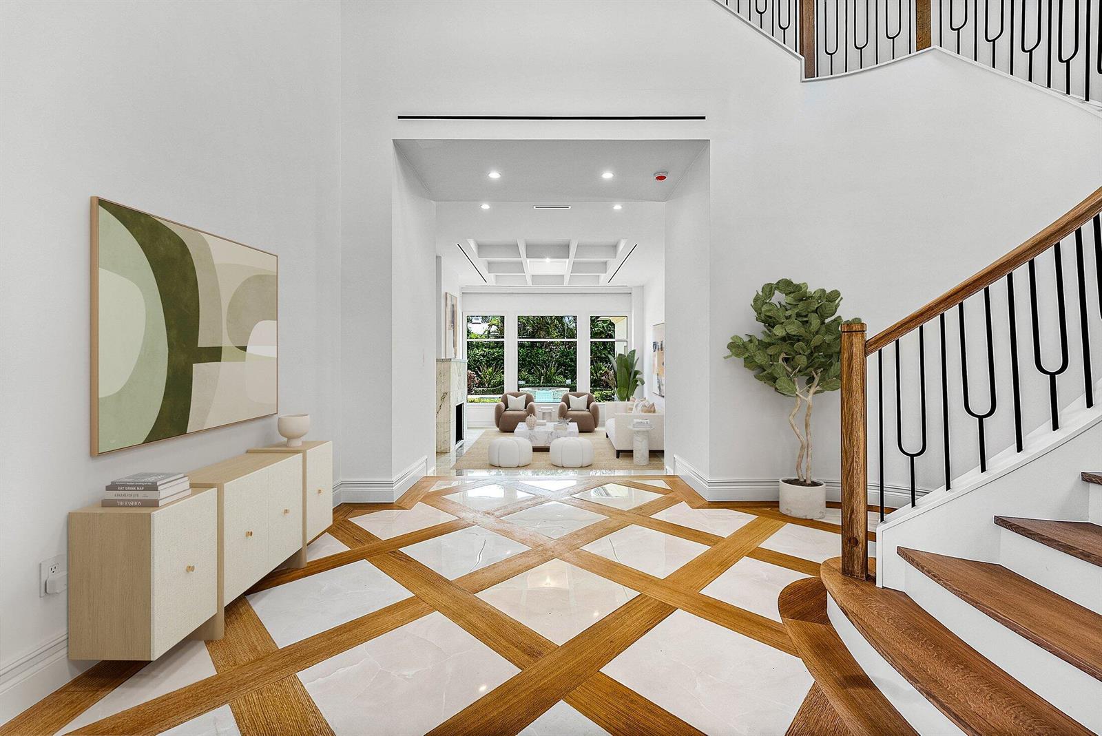 A bright foyer features a geometric wood and marble floor, a staircase, and a living area — 2002 NW 4th Avenue, Delray Beach FL 33444, DELRAY BEACH, FL
