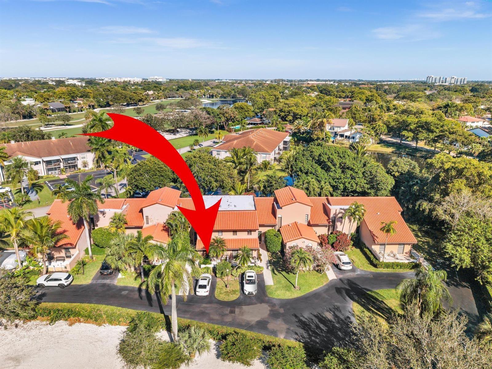 An aerial view shows a multi-unit residential building with red tile roofs and palm trees — 9050 Jacaranda Lane # 3, Plantation FL 33324, PLANTATION, FL