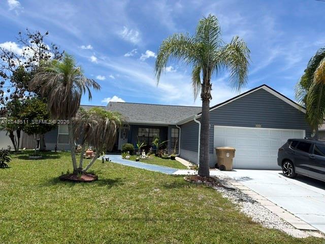 A single-story house with gray siding, a white garage door, and palm trees in front — 263 Cranbrook Dr, Kissimmee FL 34758, KISSIMMEE, FL