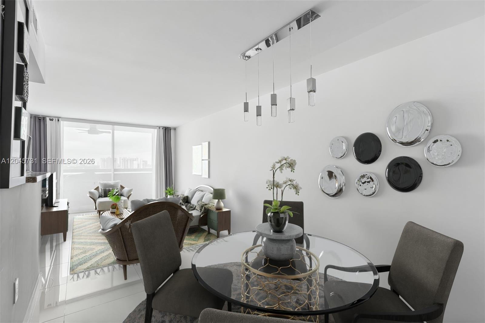 A dining area with a glass table and chairs sits in front of a living room — 1775 Washington Ave # 14F, Miami Beach FL 33139, MIAMI BEACH, FL