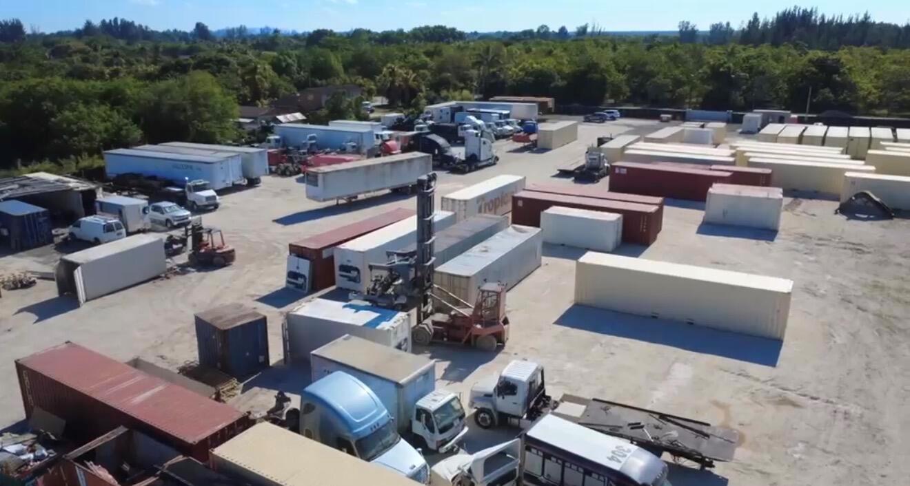 An aerial view of a storage yard filled with shipping containers, semi-trucks, and trailers — 12485 SW 197th Avenue, Miami FL 33196, MIAMI, FL