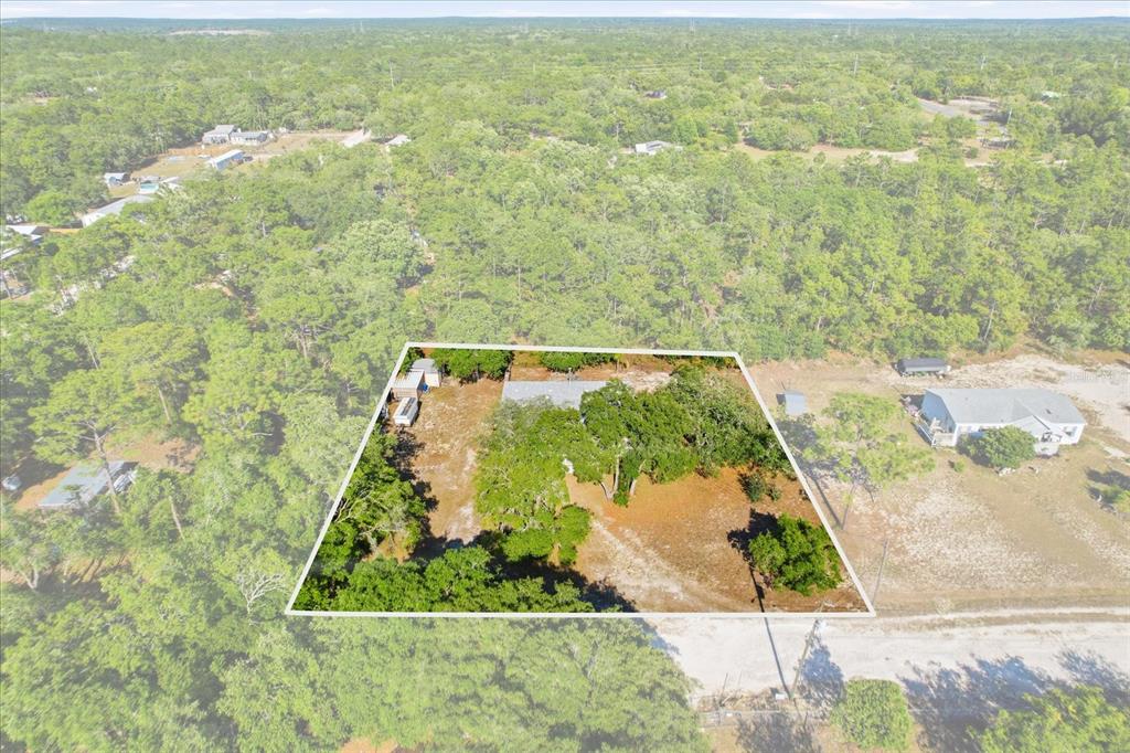 An aerial view shows a rectangular property lot with a house surrounded by trees — 5015 S ORWELL POINT, HOMOSASSA, FL