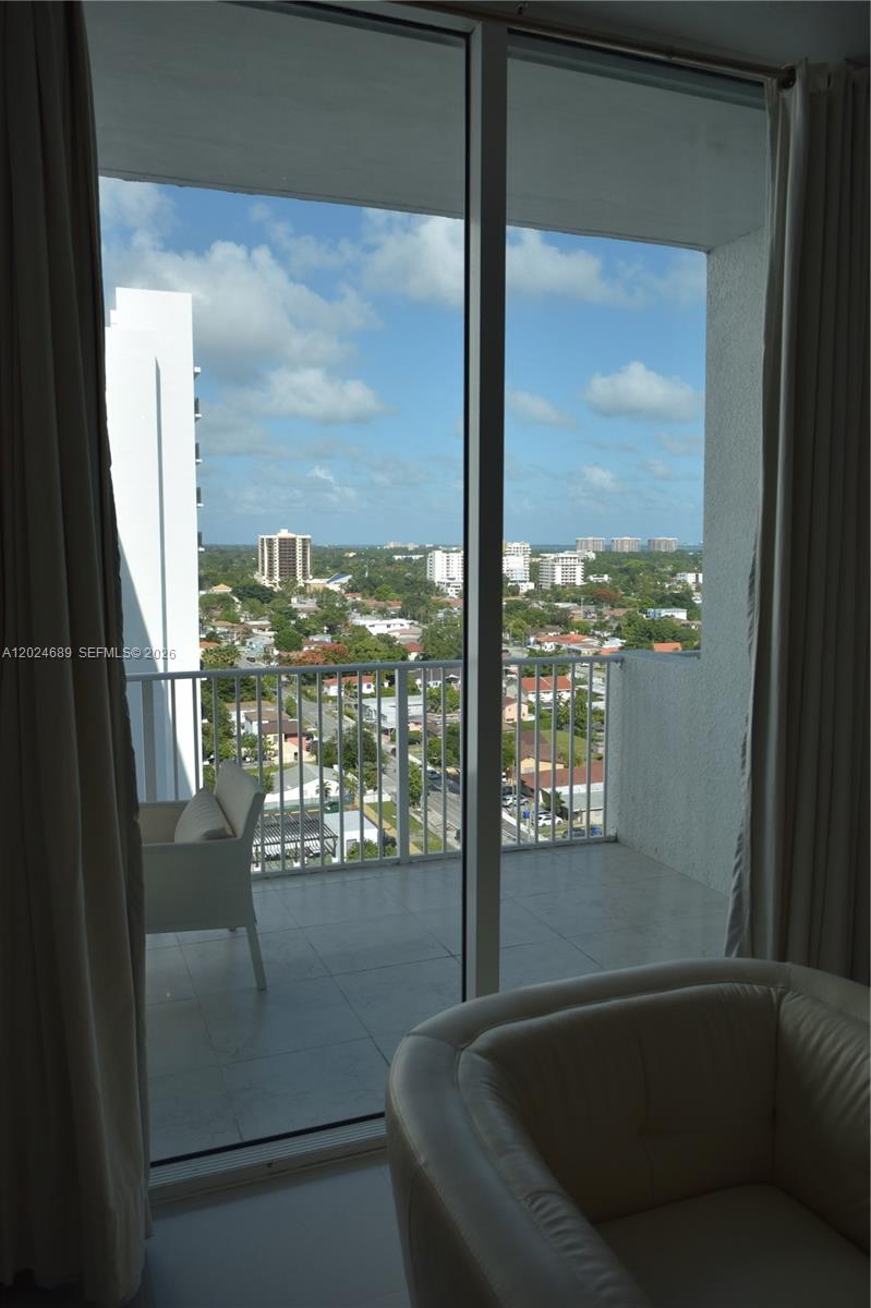 A view from a room looking out onto a balcony with a city skyline — 3180 SW 22nd Ter, Miami FL 33145, MIAMI, FL