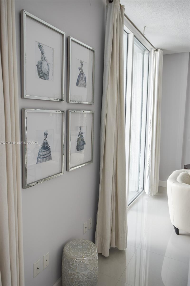 A room features four framed fashion prints on a gray wall beside floor-to-ceiling curtains — 3180 SW 22nd Ter, Miami FL 33145, MIAMI, FL