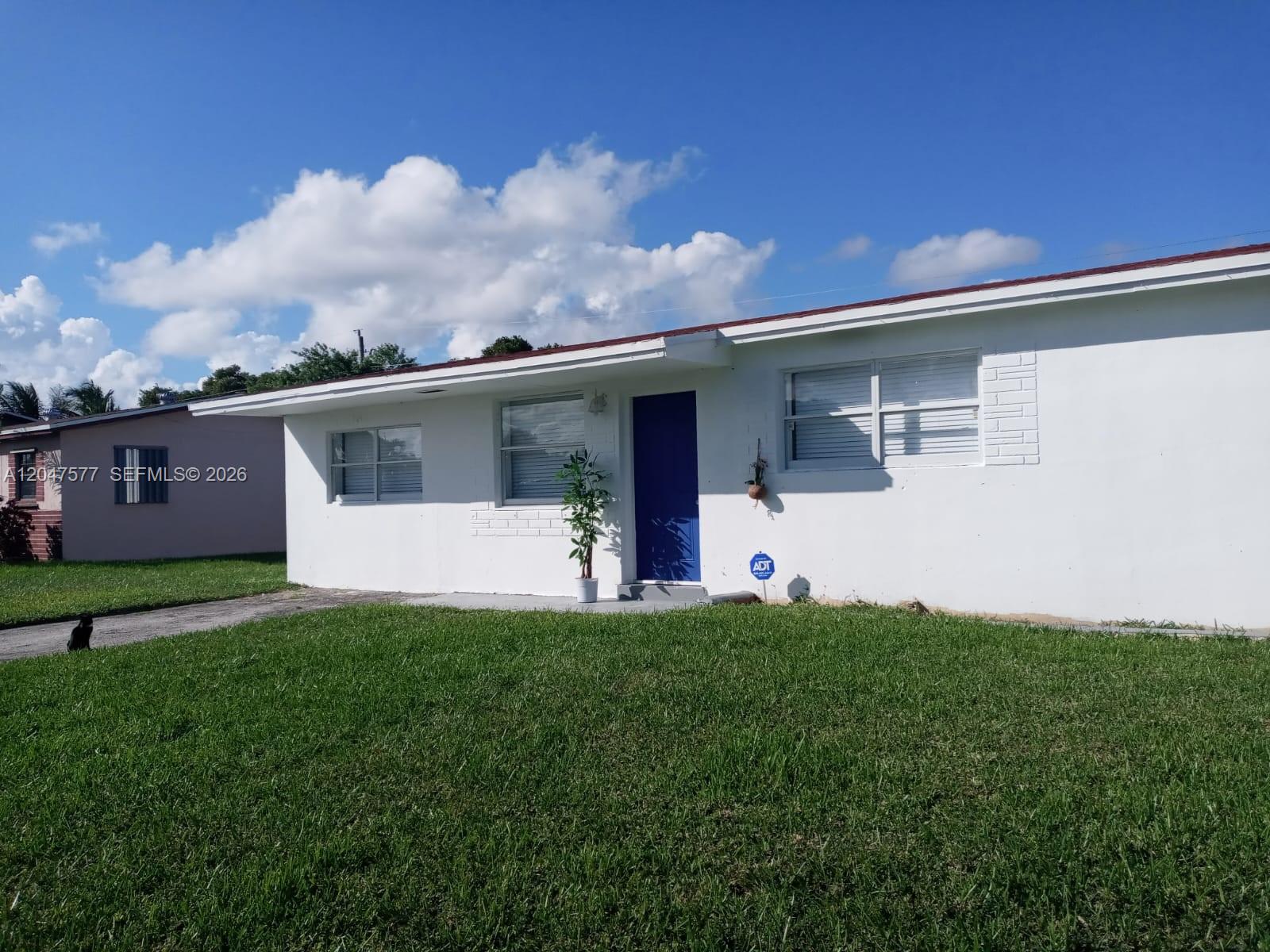A room features a blue door, a window with blinds, and a ceiling fan — 10961 SW 222nd Ter, Miami FL 33170, MIAMI, FL