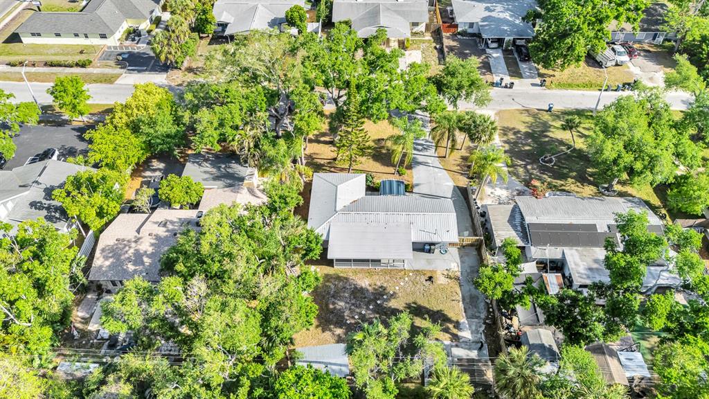 An aerial view shows a residential neighborhood with several houses surrounded by mature trees — 2510 51ST AVENUE TERRACE W, BRADENTON, FL