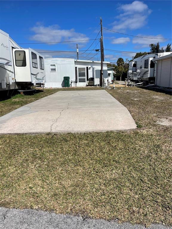 A concrete pad sits between two recreational vehicles in a mobile home park — 86 MICHIGAN STREET, PALMETTO, FL