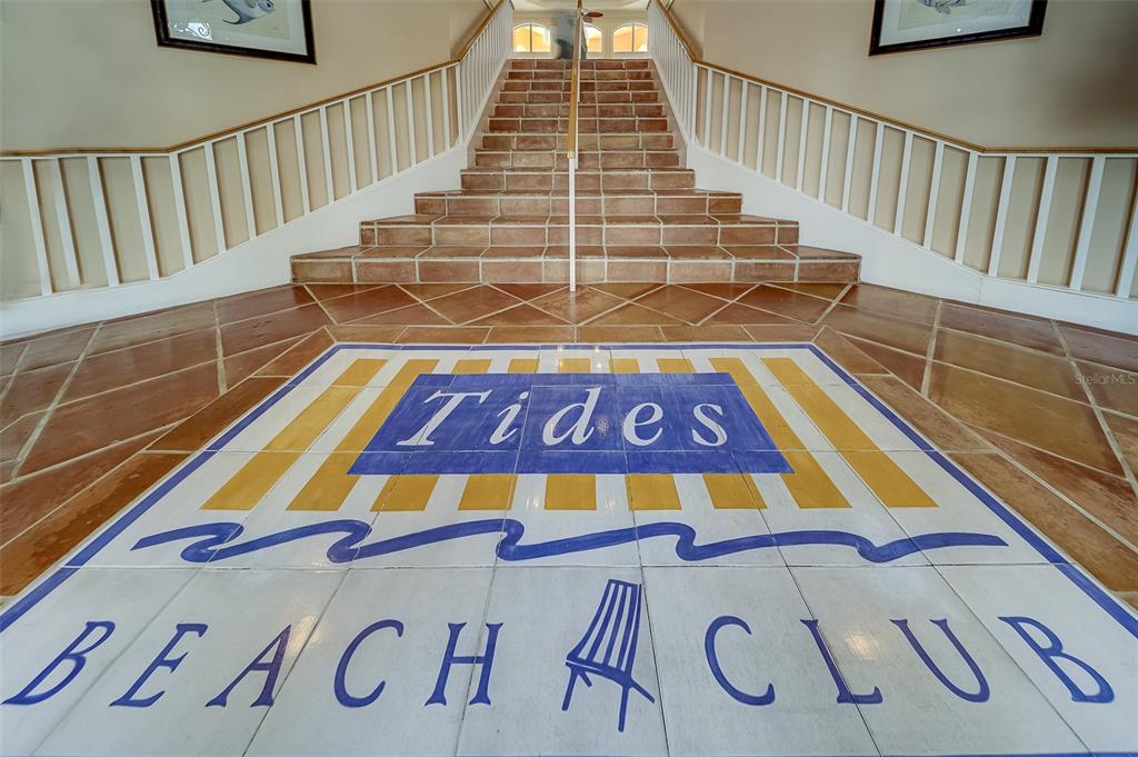 A tiled staircase leads up from a lobby floor featuring a Tides Beach Club logo — 16500 GULF BOULEVARD UNIT 355, NORTH REDINGTON BEACH, FL