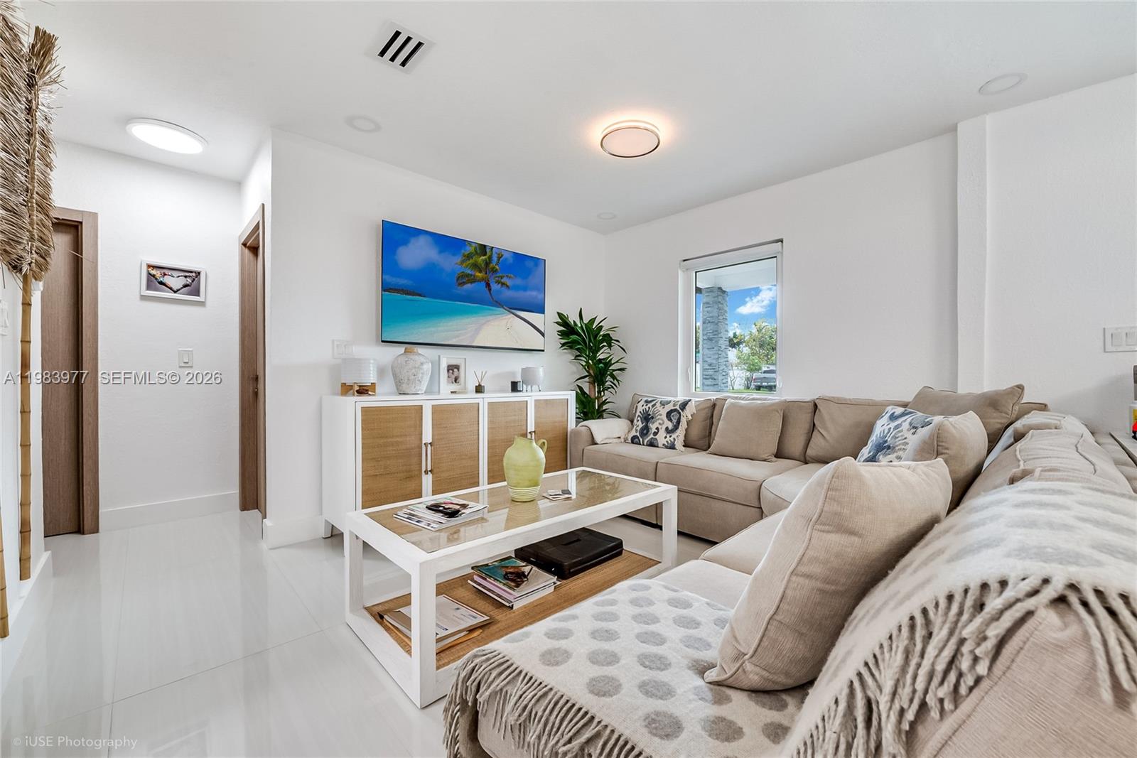 A living room features a beige sectional sofa, a glass-topped coffee table, and a television — 7235 SW 39th St, Miami FL 33155, MIAMI, FL
