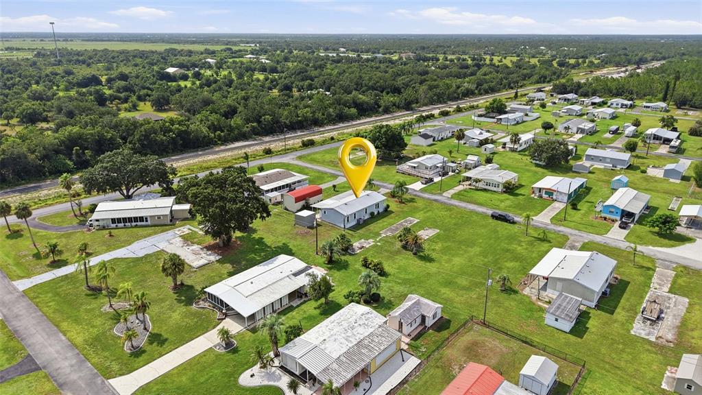 An aerial view shows a residential neighborhood with several single-story homes and a yellow pin — 29228 MARYLU AVENUE, PUNTA GORDA, FL