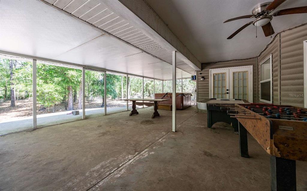 A single-story house with a gravel yard, fire pit, and covered porch — 2060 NE 100TH ST ROAD, BRANFORD, FL