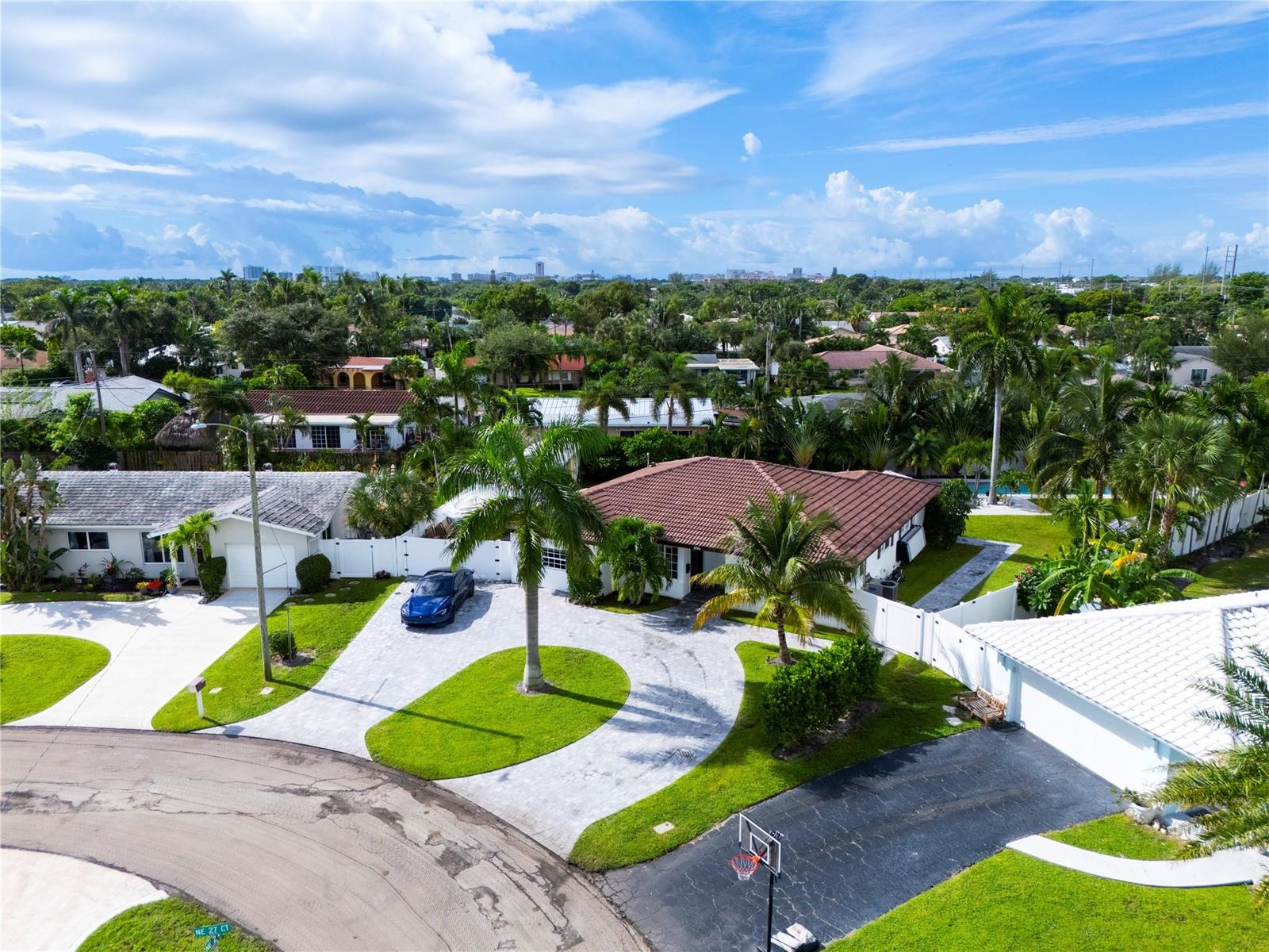 An aerial view shows a suburban house with a tiled roof, circular driveway, and palm trees — 250 NE 27th Court, Boca Raton FL 33431, BOCA RATON, FL