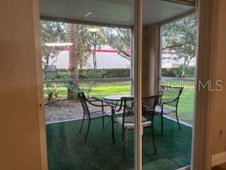 A screened-in patio features a small table, four chairs, and green outdoor carpeting — 824 CAMARGO WAY UNIT 106, ALTAMONTE SPRINGS, FL