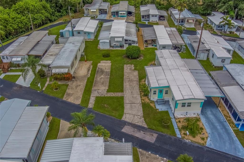 An aerial view shows several mobile homes with metal roofs and driveways in a park — 16940 US HIGHWAY 19 N UNIT 244, CLEARWATER, FL