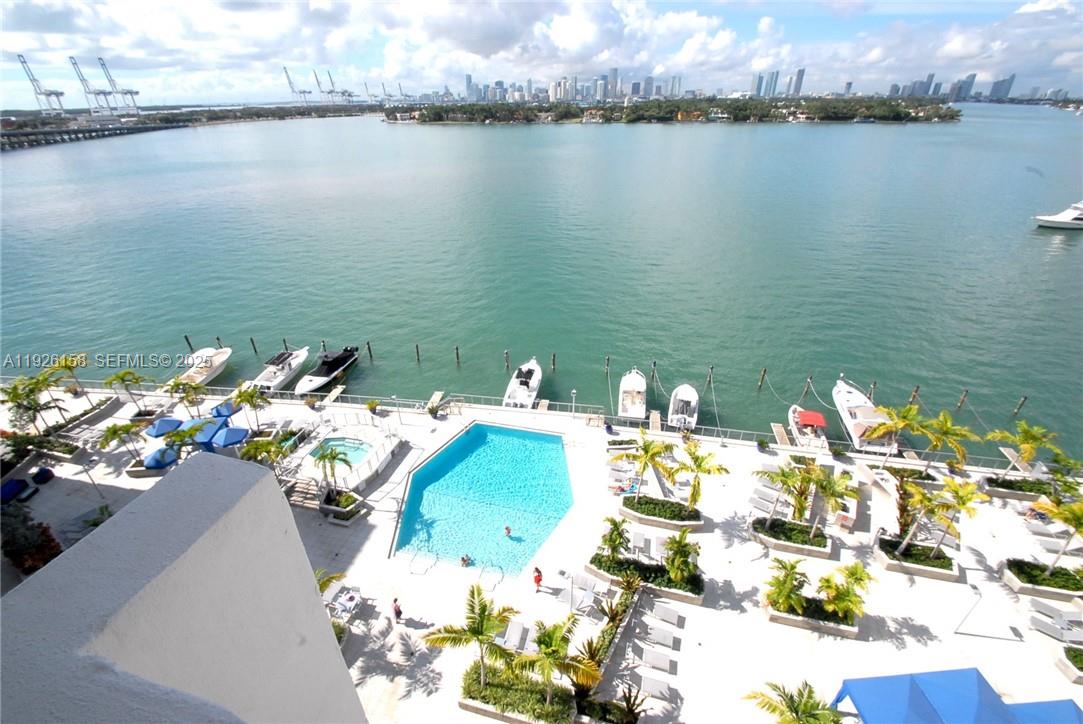 An aerial view shows a swimming pool, hot tub, and boat slips overlooking a bay — 800 West Ave, Miami Beach FL 33139, MIAMI BEACH, FL