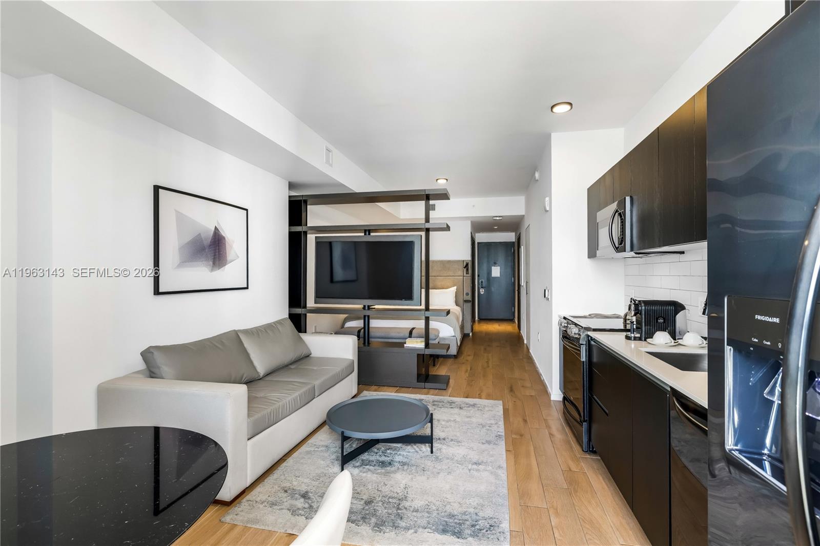 A studio apartment features a kitchenette, a living area with a sofa, and a bed — 398 NE 5th St # 2205, Miami FL 33132, MIAMI, FL