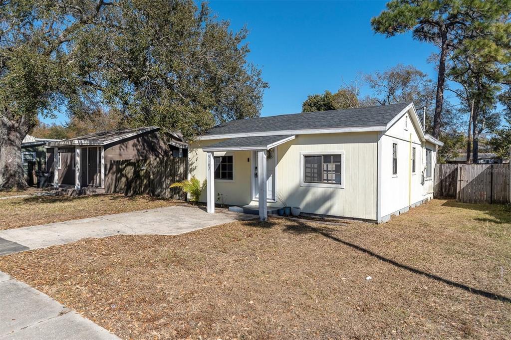 A light yellow, single-story house with a small front porch and a concrete driveway — 5107 37TH STREET N, ST PETERSBURG, FL