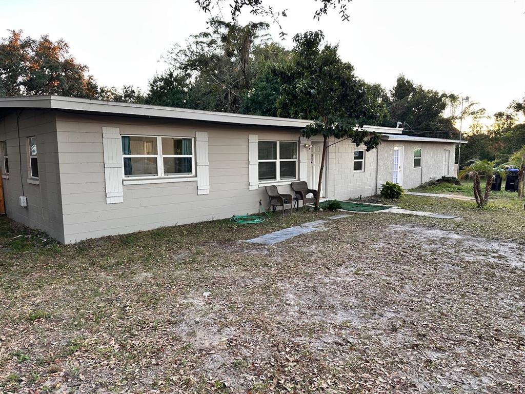 A single-story house with light gray siding, white shutters, and a concrete block exterior — 3508 ORANOLE ROAD, ORLANDO, FL