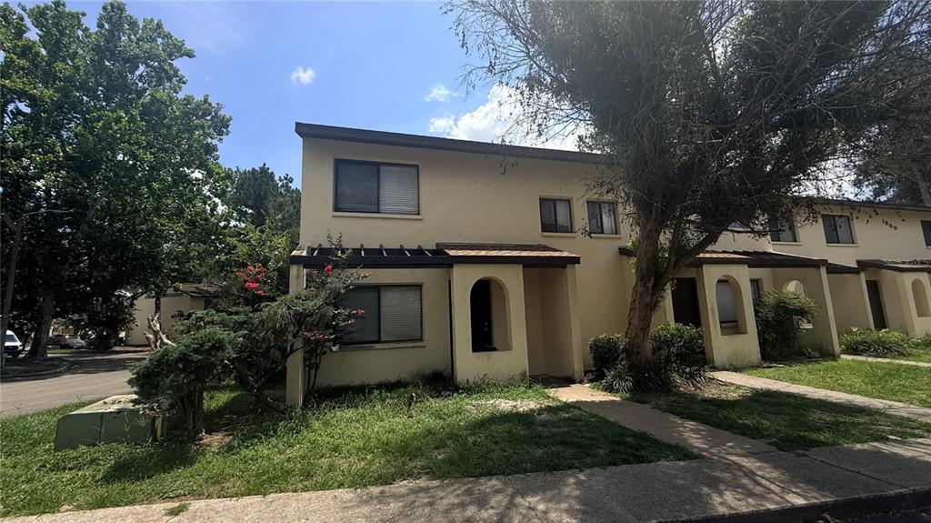 A two-story tan townhouse with a flat roof and a small front porch — 2735 SW 35TH PLACE UNIT 1801, GAINESVILLE, FL