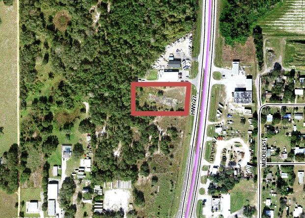 This aerial map shows a rectangular vacant lot highlighted in red along a highway — S US HIGHWAY 27, LAKE WALES, FL