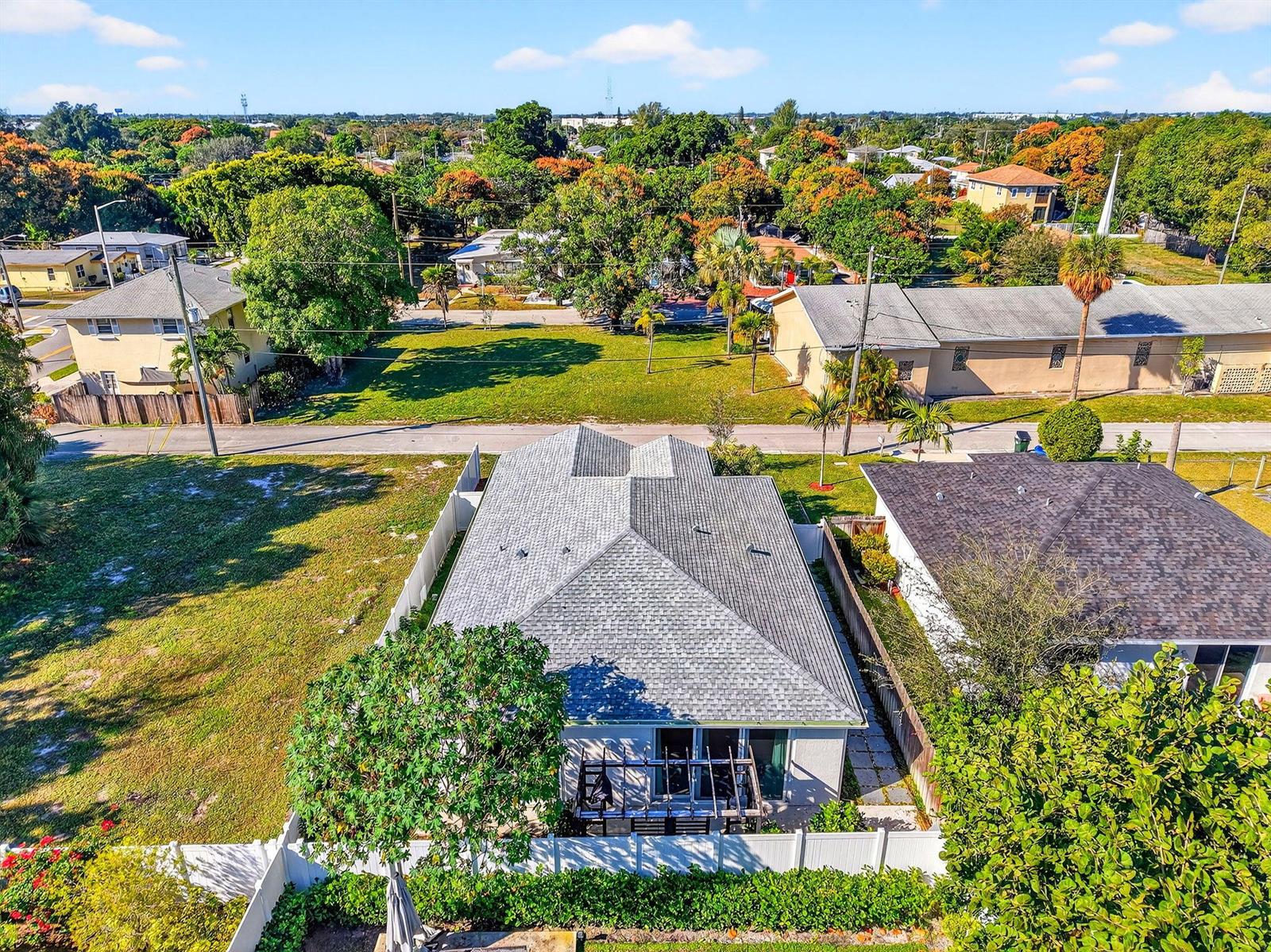 An aerial view shows a house with a gray shingled roof and a backyard pergola — 341 Oak Alley, Delray Beach FL 33444, DELRAY BEACH, FL