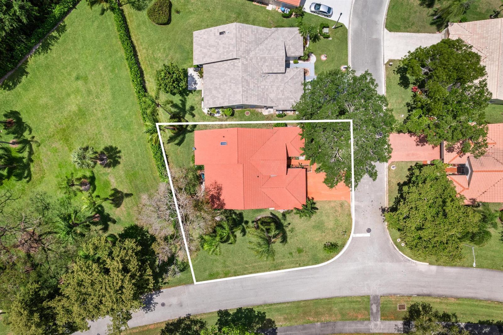 An aerial view shows a house with a red tile roof on a corner lot — 8521 Leeway Lane, Boynton Beach FL 33436, BOYNTON BEACH, FL