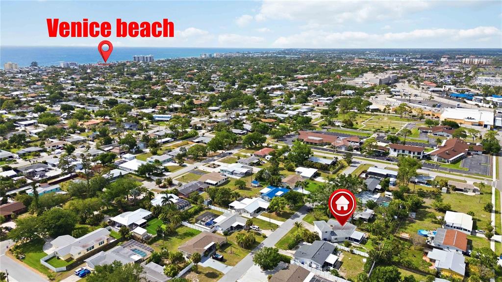 An aerial view shows a residential neighborhood with a house highlighted by a red icon — 917 CHURCH STREET, VENICE, FL